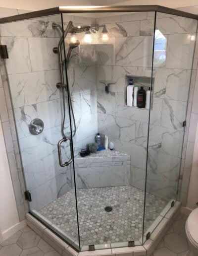 3/8-inch frameless neo-angle glass shower door with brushed nickel hardware